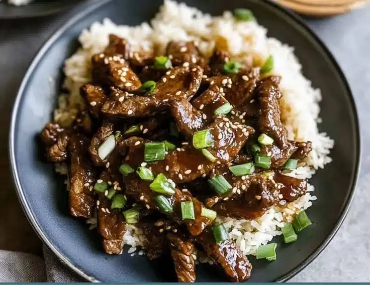 Delicious plate of Mongolian Beef garnished with green onions
