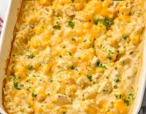 A delicious Chicken Rice Casserole topped with herbs and cheese, served in a baking dish.