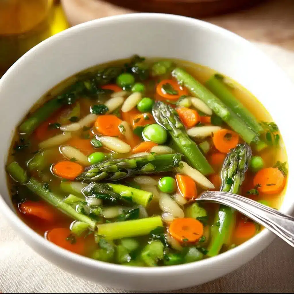 A bowl of fresh Spring Vegetable Soup filled with colorful vegetables and herbs.